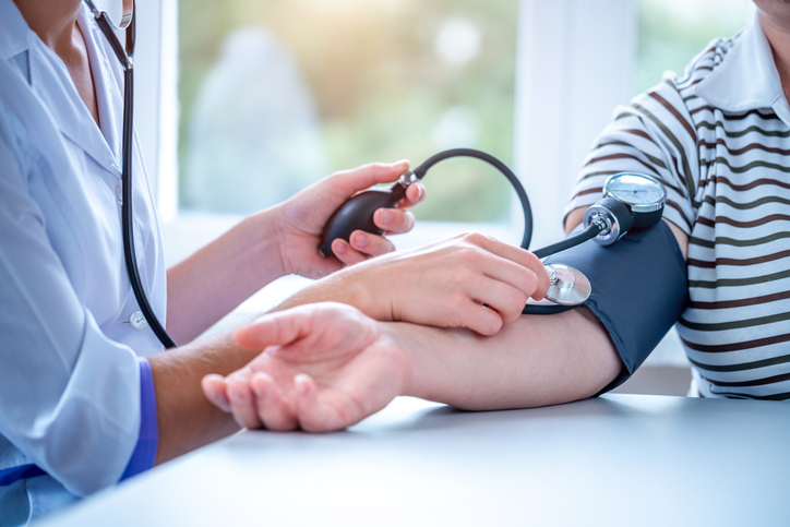 Headaches and Blood Pressure Patient with headache and high blood pressure receiving a medical evaluation at 14 Street Medical Arts in New York City