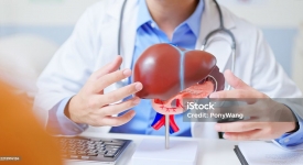 Physician evaluating a patient with abdominal pain, bloating, and possible liver disease using advanced imaging at 14 Street Medical Arts