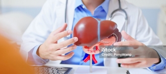 Physician evaluating a patient with abdominal pain, bloating, and possible liver disease using advanced imaging at 14 Street Medical Arts
