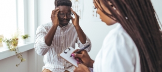 Board-certified neurologist evaluating a patient with chronic headaches and migraines at 14 Street Medical Arts